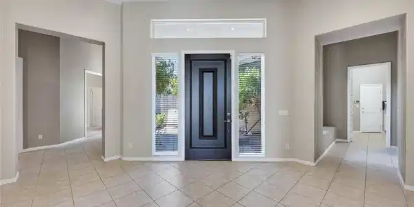 Image 4: This spacious entry welcomes guests with ample nat
