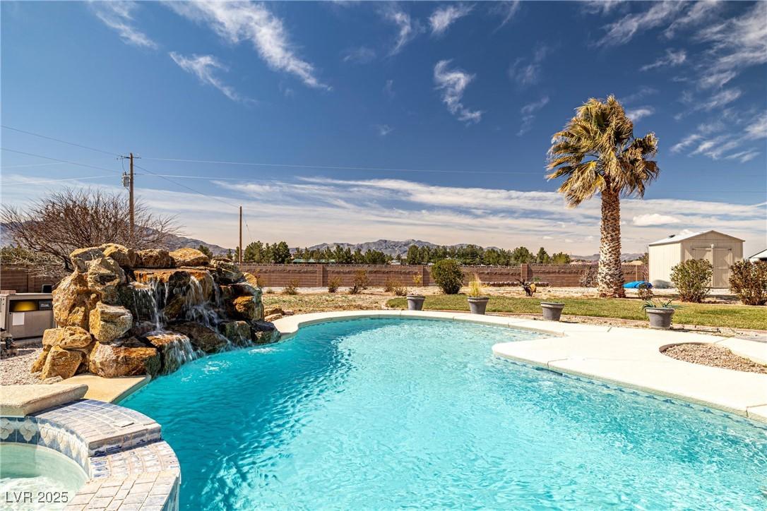 Image 4: View of swimming pool with a fenced in pool and a