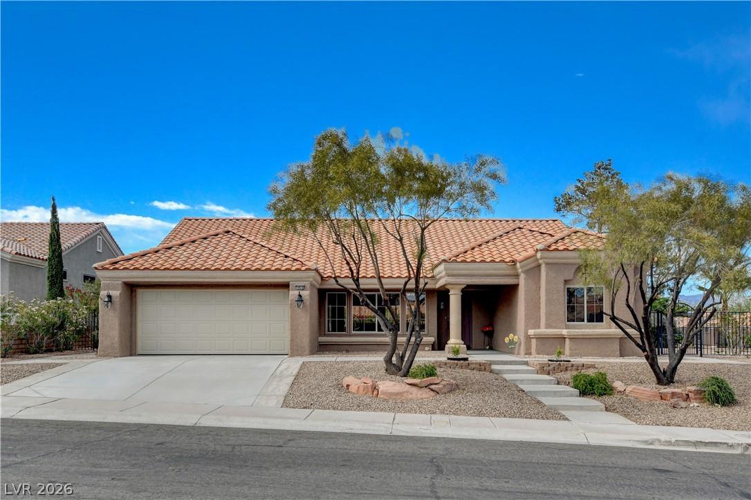 Image 2: This desert-style home features a beautiful tile r