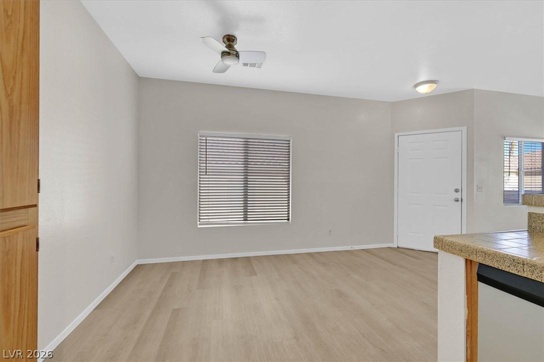 Image 3: A well-lit living area features easy-care wood flo