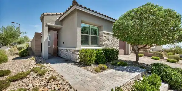 Image 2: Stone accents and a paved walkway create a welcomi