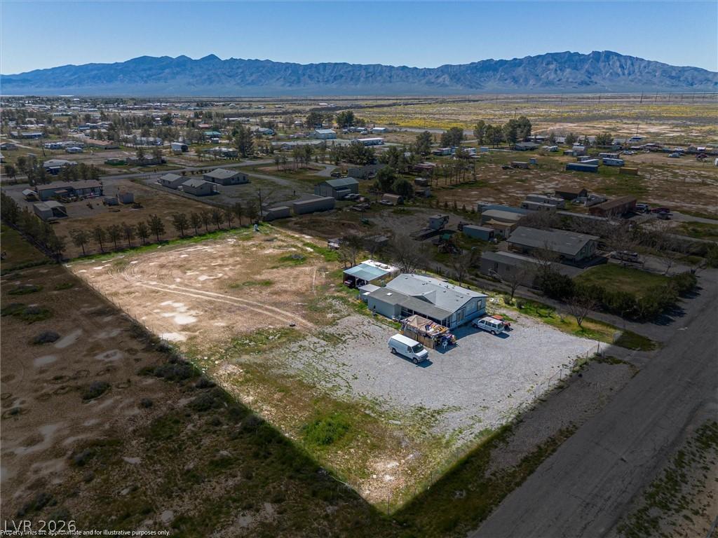 Image 1: Aerial view of sparsely populated area with a moun