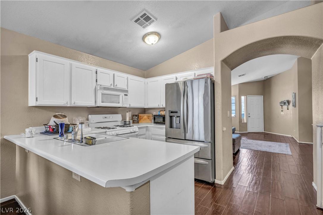 Image 2: This functional kitchen features ample counter spa