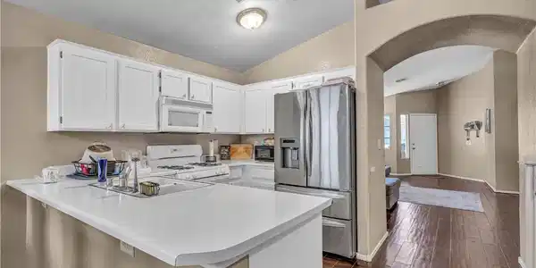 Image 2: This functional kitchen features ample counter spa