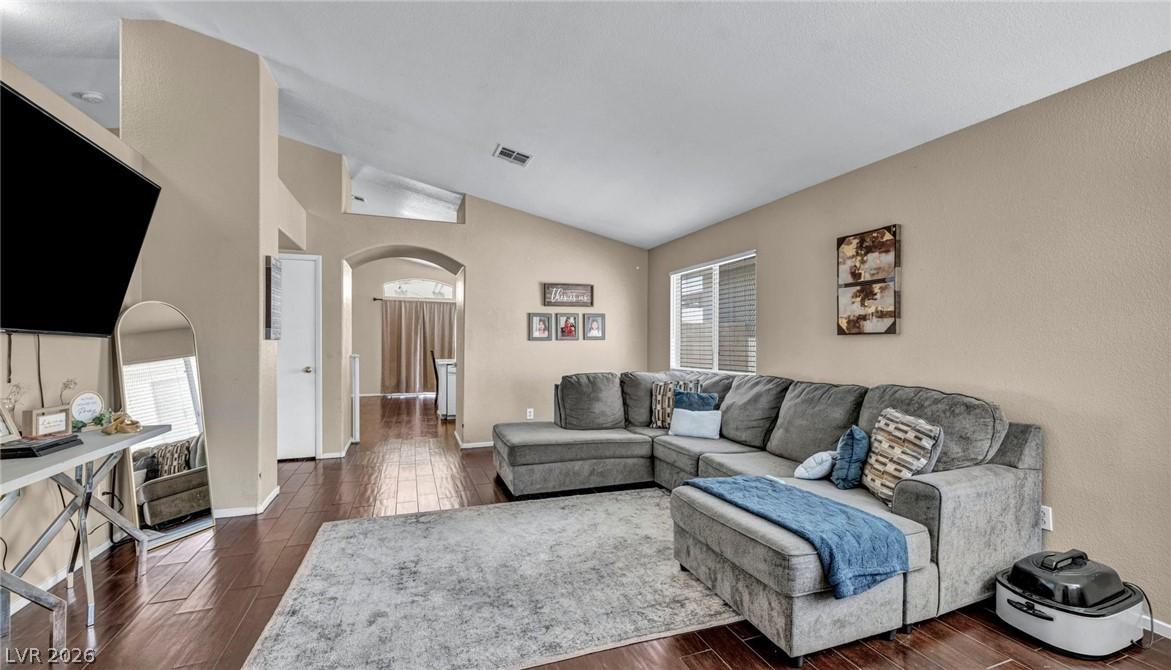 Image 3: This inviting living area boasts rich hardwood flo