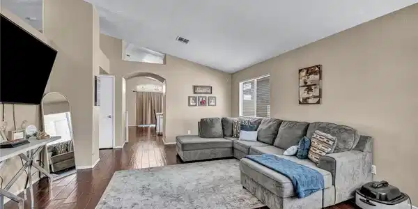 Image 3: This inviting living area boasts rich hardwood flo