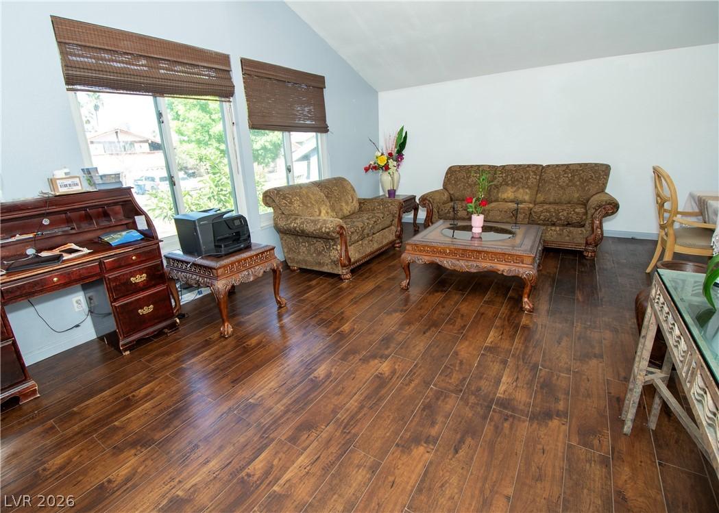 Image 2: Hardwood floors stretch across this living space,