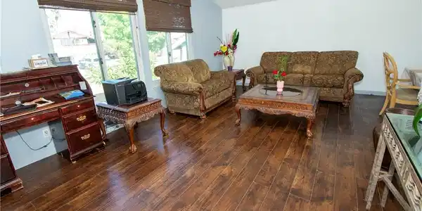 Image 2: Hardwood floors stretch across this living space,