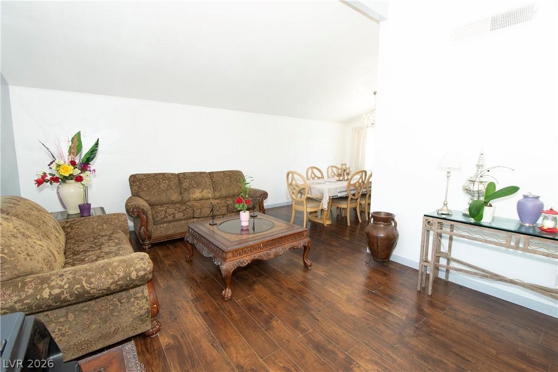 Image 3: Rich hardwood floors flow through this welcoming l