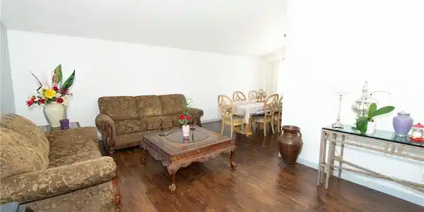 Image 3: Rich hardwood floors flow through this welcoming l