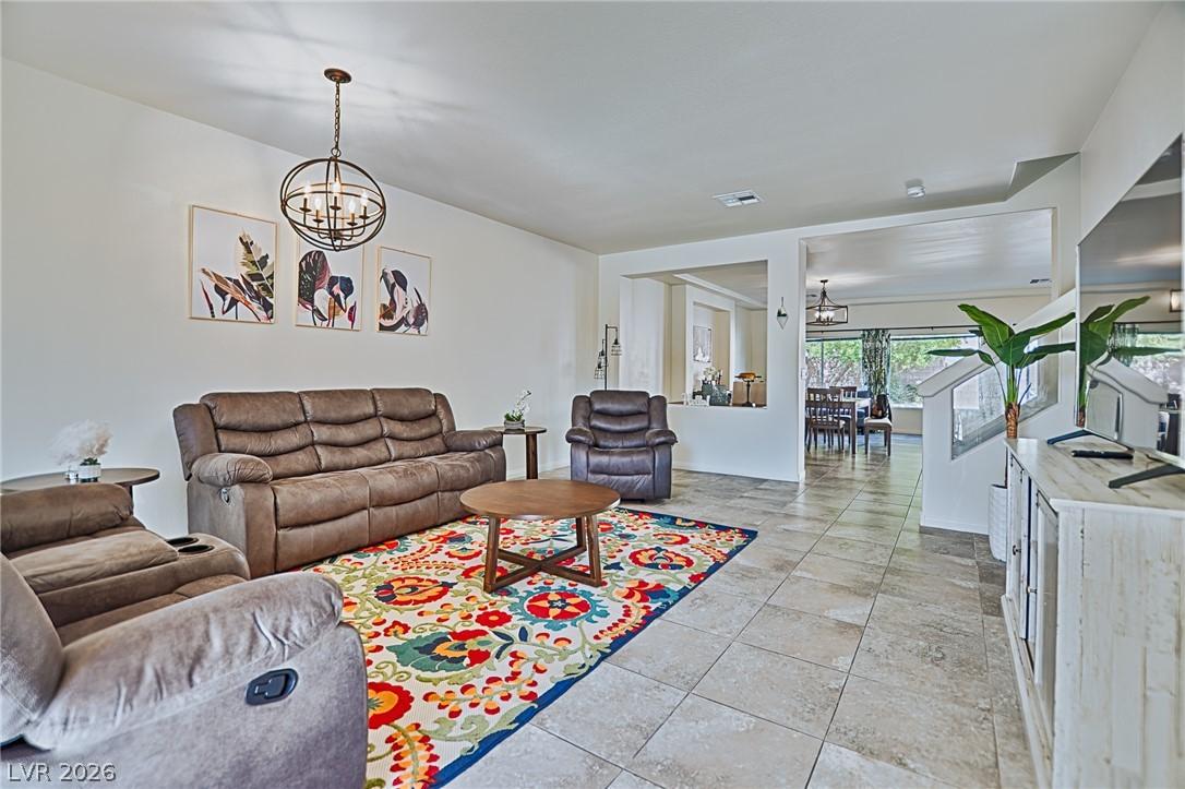 Image 2: An inviting family room connects seamlessly to a f