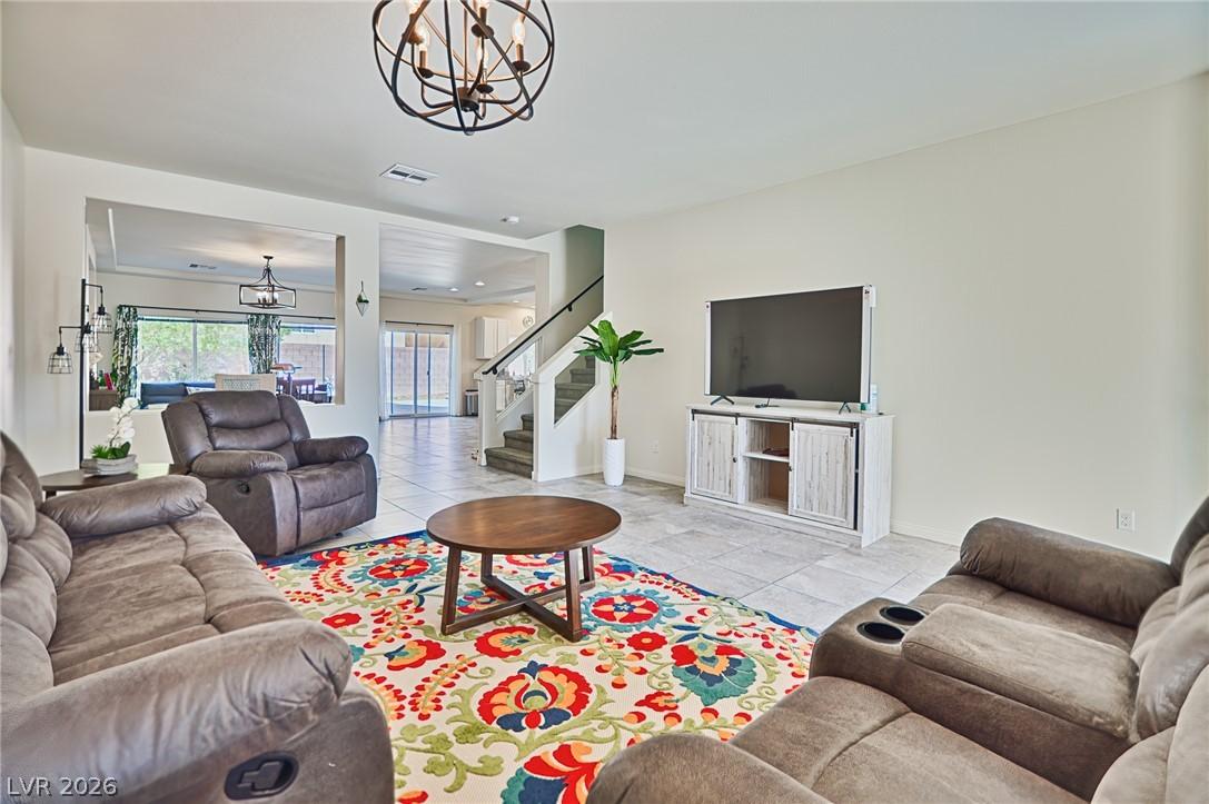 Image 3: A vibrant area rug anchors this inviting living sp
