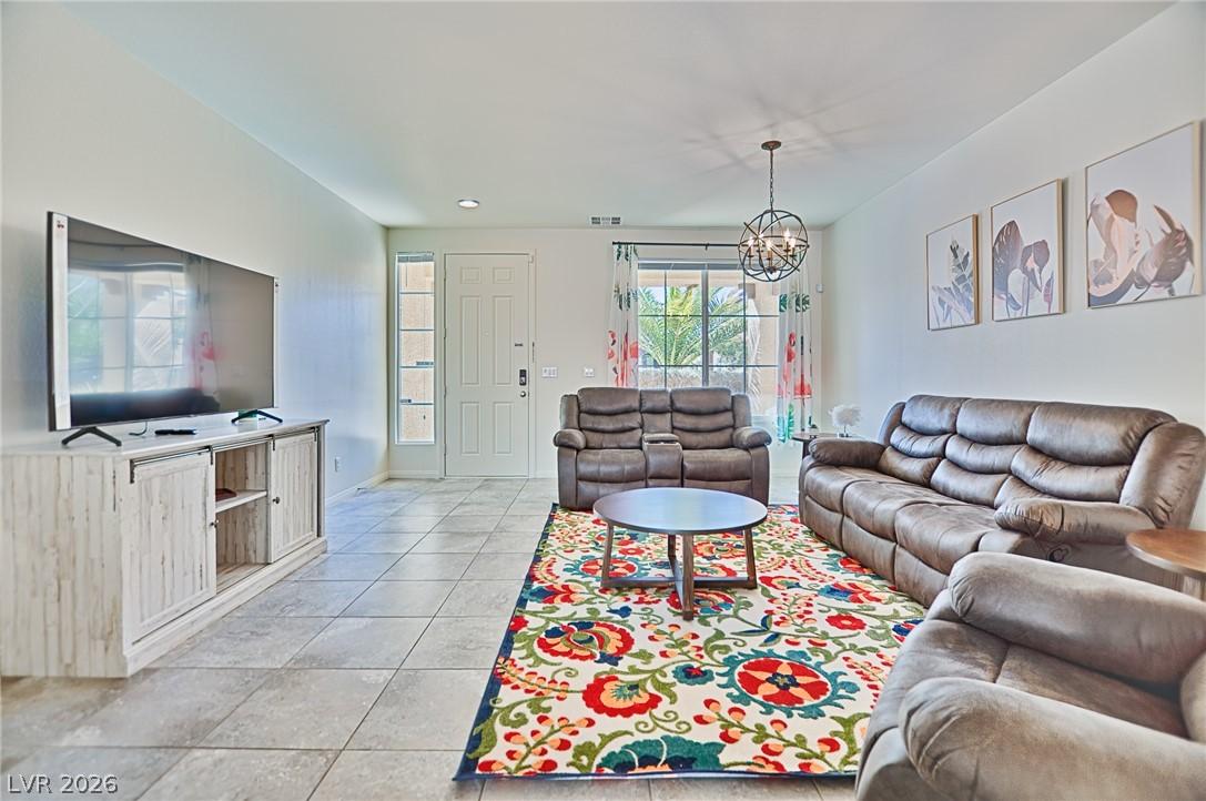 Image 4: The living room offers durable tile flooring, prov