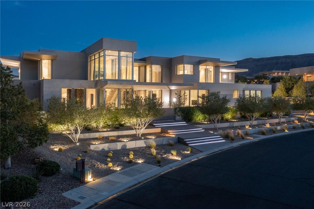 Image 1: Modern architecture glows at twilight, featuring t