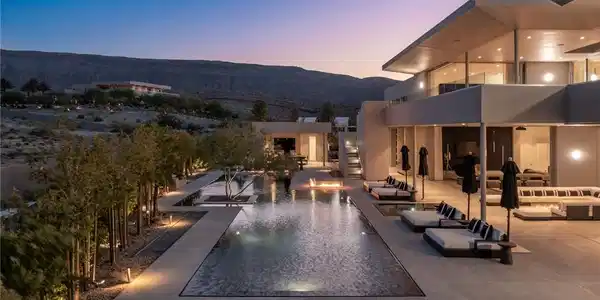 Image 3: An illuminated desert oasis features a long swimmi