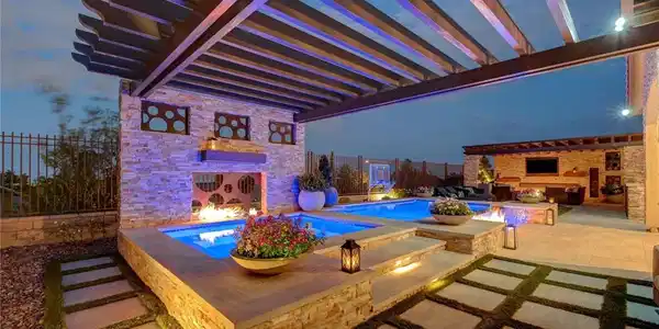 Image 2: An illuminated backyard oasis presents a multi-lev