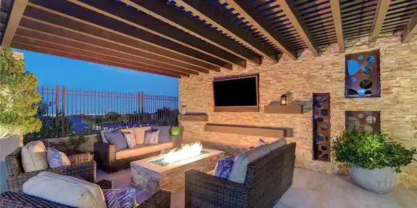 Image 3: An inviting outdoor living space features a cozy f
