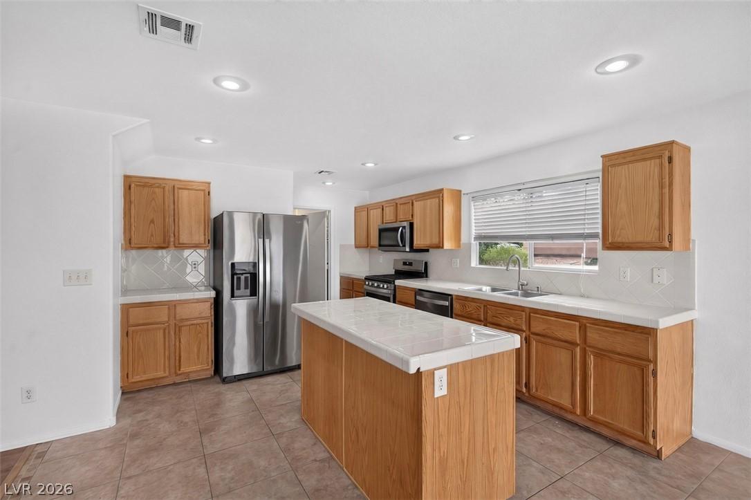 Image 4: A well-equipped culinary space boasts ample cabine