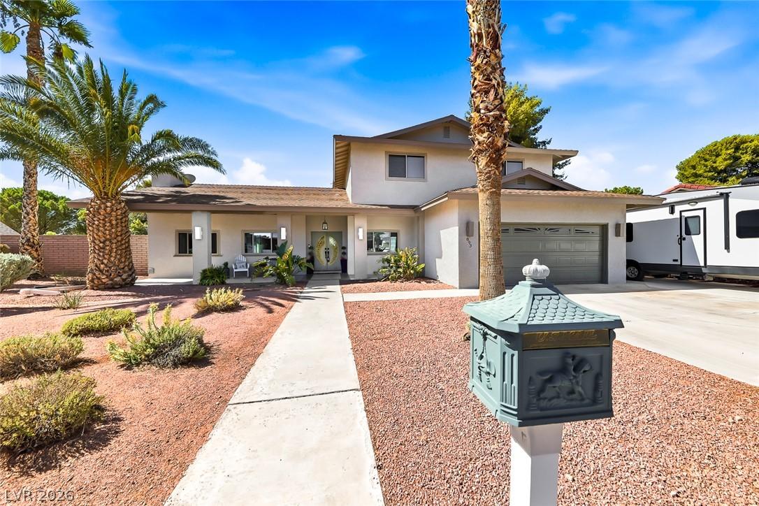 Image 2: A well-maintained stucco home with an attached gar