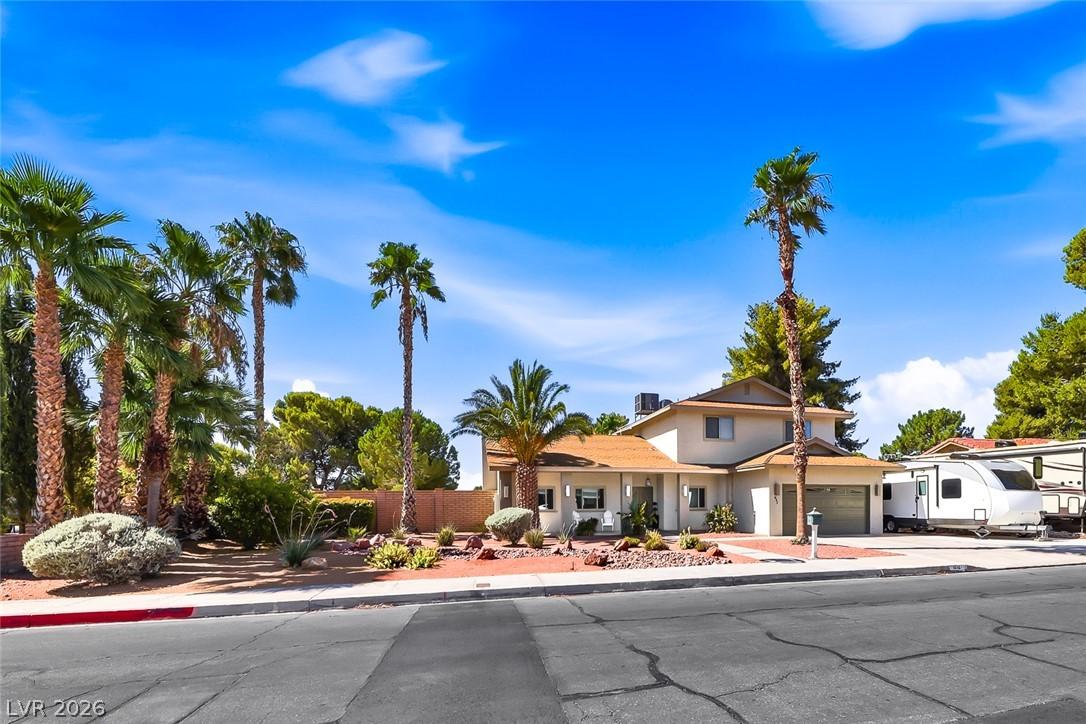 Image 3: Mature palm trees and desert landscaping adorn thi