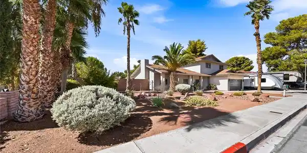Image 4: Mature palm trees and xeriscaping provide a welcom