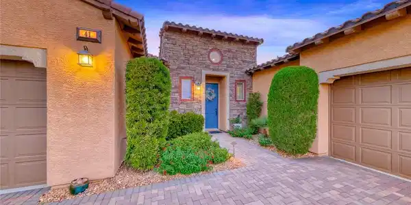Image 4: An inviting stone-accented entryway features a pav