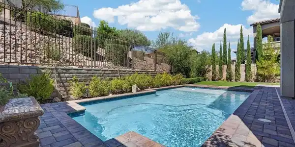 Image 3: An inviting swimming pool bordered by stone pavers