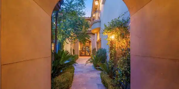 Image 3: An elegant stone archway frames the lushly landsca