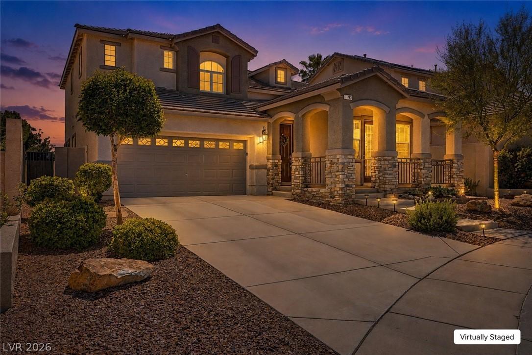 Image 2: An inviting front entry with stone accents and a s