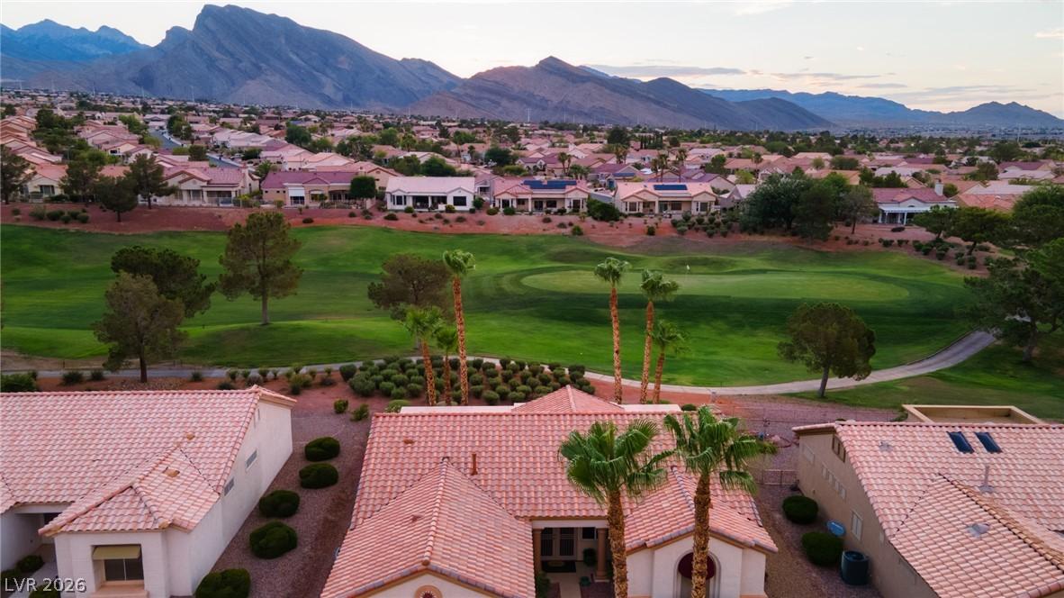Image 3: Perched above a verdant golf course, this home enj