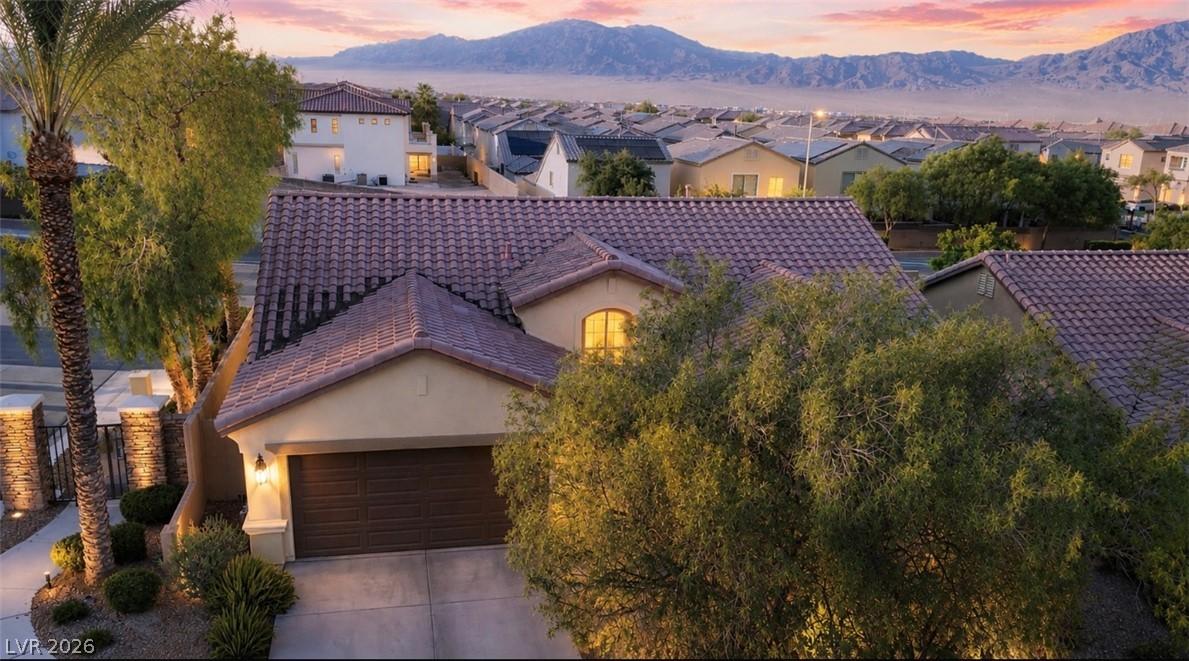 Image 2: A terracotta tile roof crowns this inviting home,