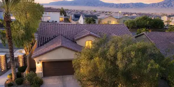 Image 2: A terracotta tile roof crowns this inviting home,