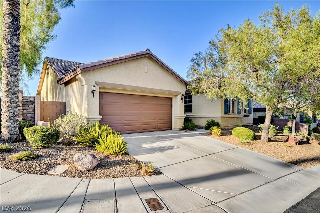 Image 3: A well-maintained stucco home offers a two-car gar