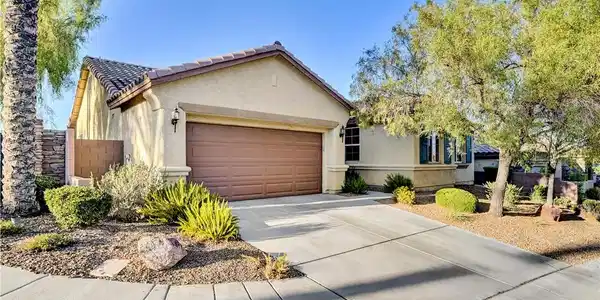 Image 3: A well-maintained stucco home offers a two-car gar