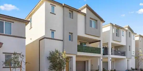 Image 2: Back of house featuring stucco siding, a balcony,