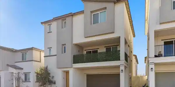 Image 3: View of front of house featuring stucco siding, a