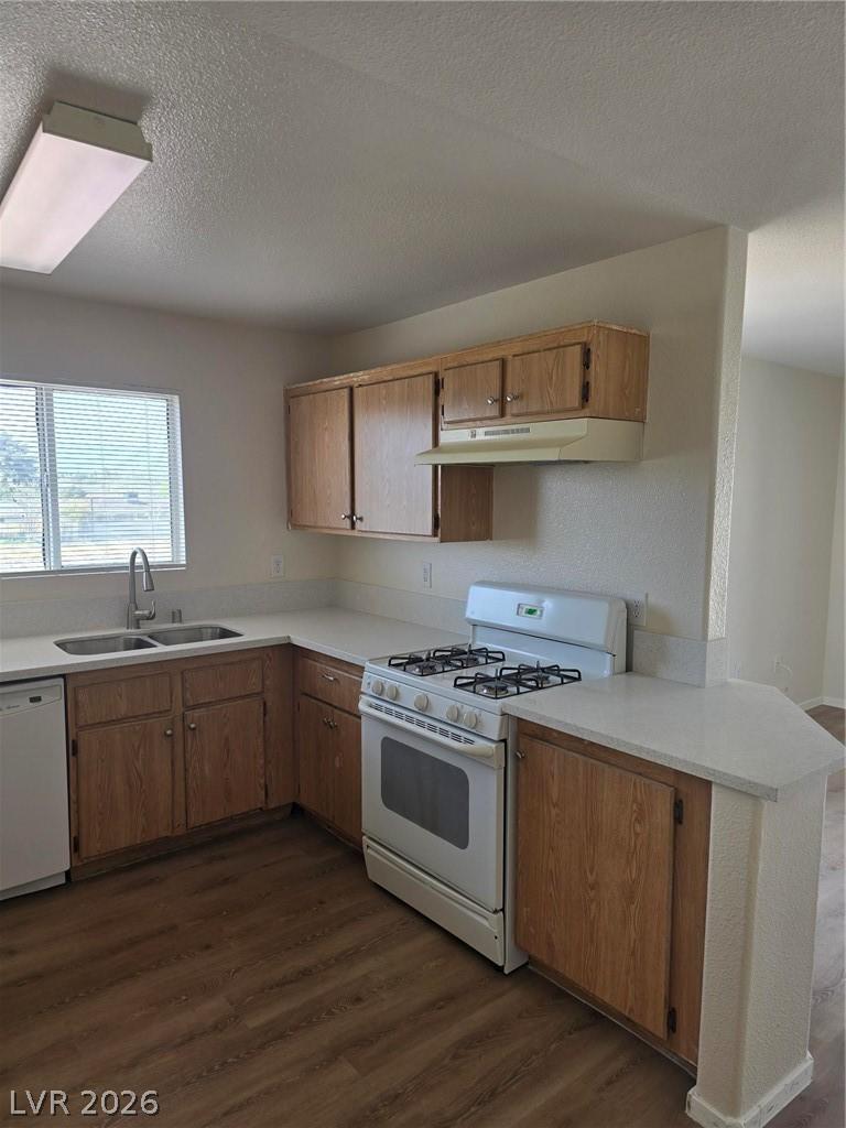 Image 2: Kitchen featuring range, dark wood finished floors