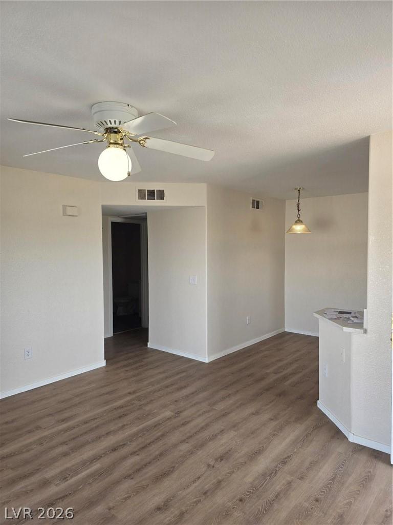 Image 4: Unfurnished room with dark wood-style flooring and
