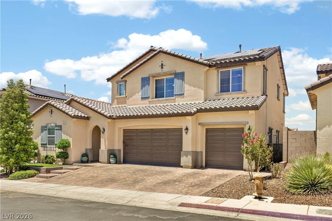 Image 2: A spacious home presents a blend of stucco and til