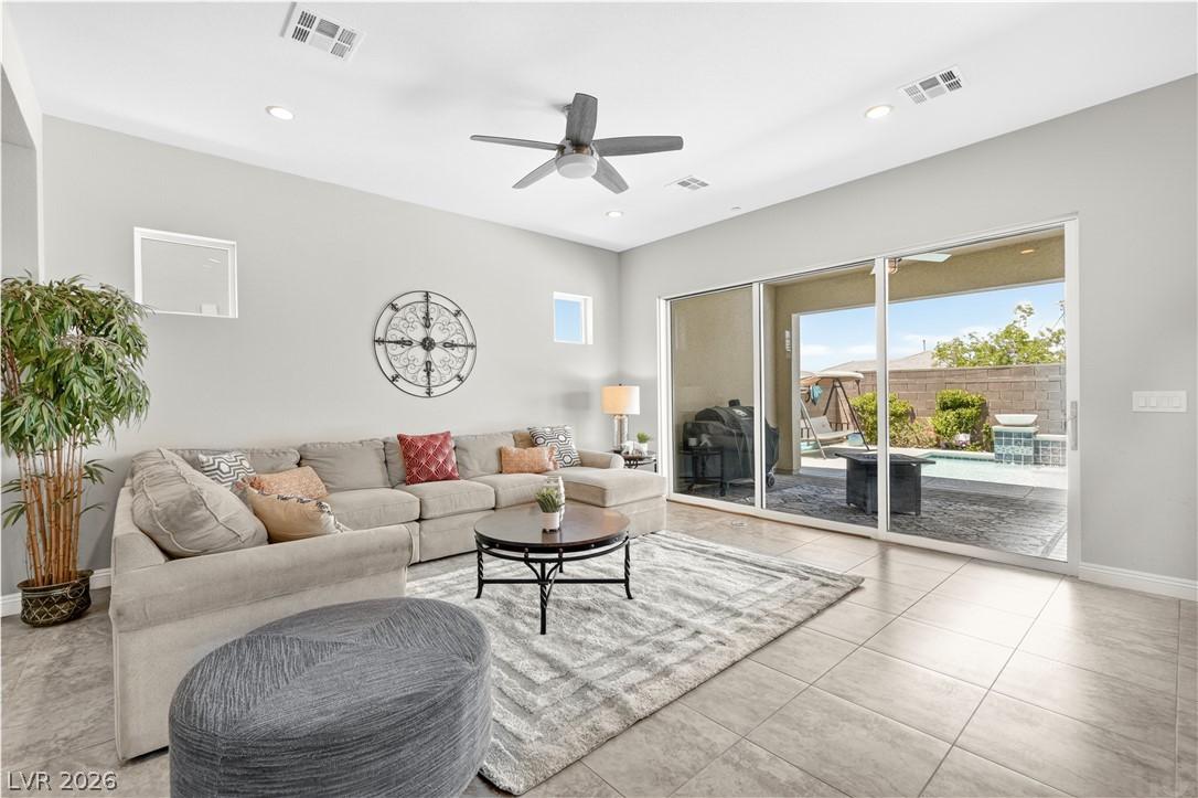 Image 3: Natural light floods this living area, offering se
