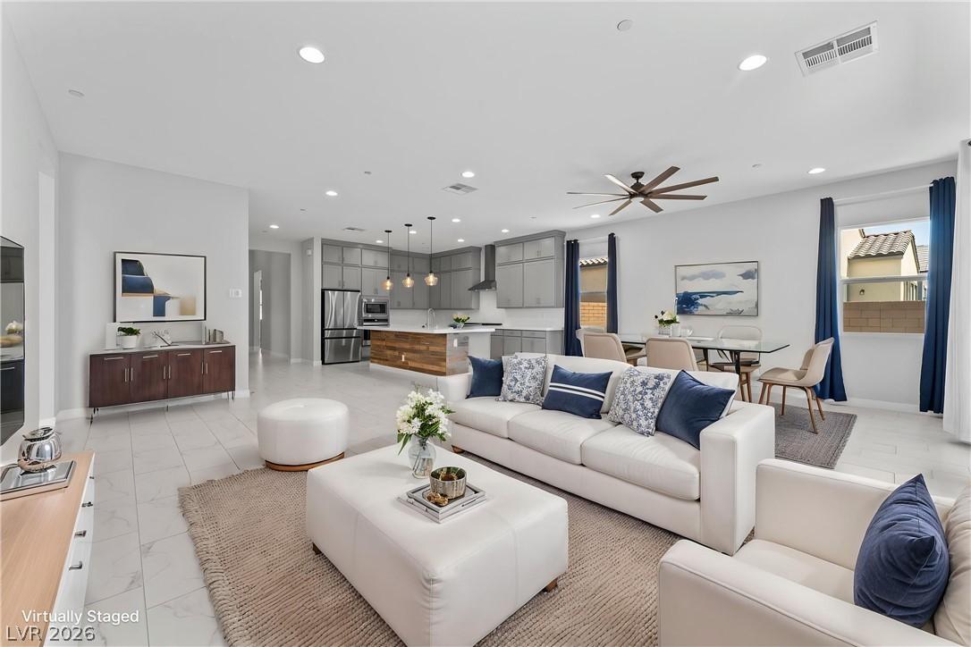 Image 2: An open-concept living space presents a seamless f