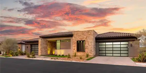 Image 2: Textured stone veneer accents and modern glass gar