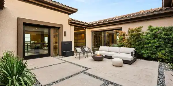 Image 3: An inviting courtyard features modern stone pavers