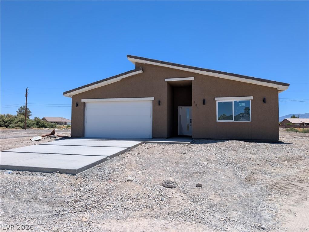 Image 1: A new construction home with an attached garage of