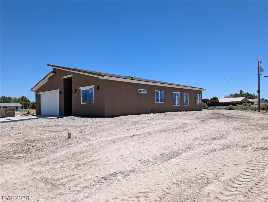 Image 3: A newly constructed residence features a crisp stu