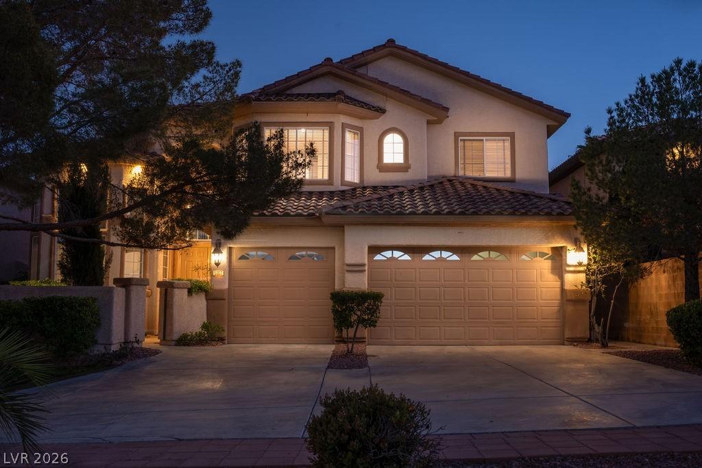 Image 3: Elegant curb appeal with exterior lighting, arched