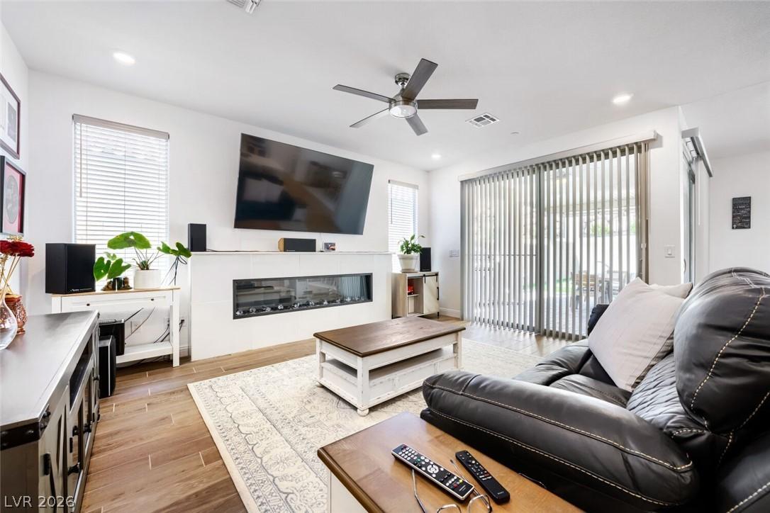 Image 4: This living room features a fireplace and wood-loo