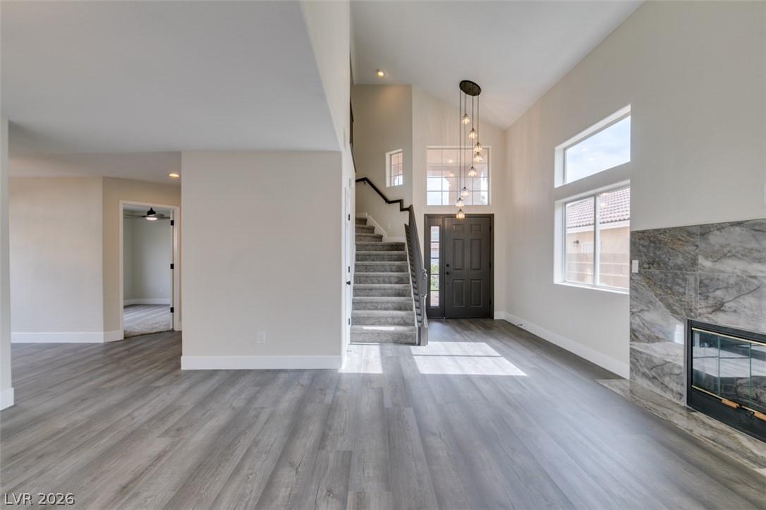 Image 4: A spacious entry features soaring ceilings, a stri
