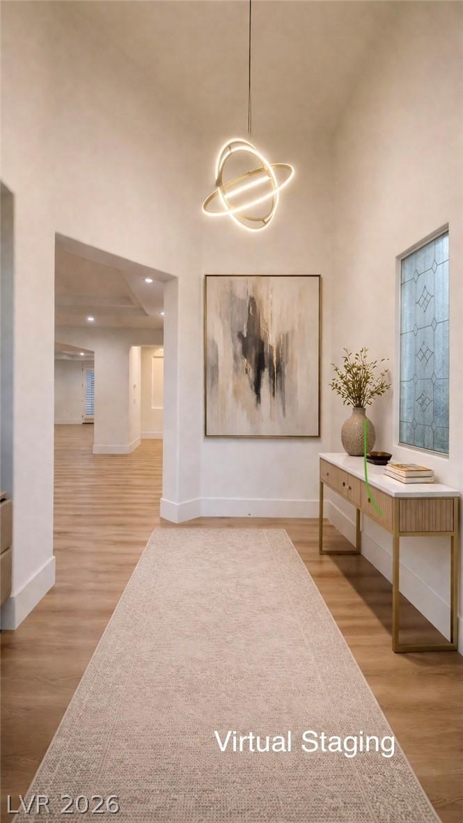 Image 3: Virtual Staging: Hallway with a high ceiling and l