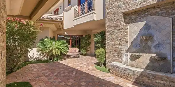 Image 4: An inviting stone-paved courtyard is anchored by a